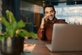 Smiling businessman talking on a cellphone while working late