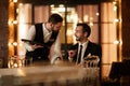 Smiling Businessman Talking to Waiter in Restaurant Royalty Free Stock Photo