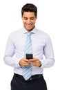 Smiling Businessman Text Messaging On Smart Phone