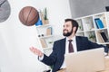 smiling businessman throwing basketball ball at workplace Royalty Free Stock Photo