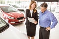 Smiling businessman undersign a car contract