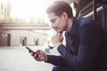 Businessman sitting at street and look at the phone. Royalty Free Stock Photo