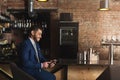 Smiling businessman using smartphone at bar Royalty Free Stock Photo