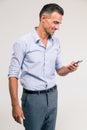 Smiling businessman using smartphone i Royalty Free Stock Photo