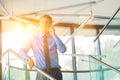 Smiling businessman using smartphone while standing at office Royalty Free Stock Photo