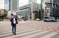 Smiling businessman walking in the city talking on his cellphone Royalty Free Stock Photo