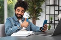 Smiling businessman wearing casual wear sitting having online video call Royalty Free Stock Photo