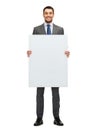 Smiling businessman with white blank board Royalty Free Stock Photo