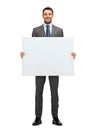 Smiling businessman with white blank board Royalty Free Stock Photo