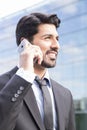 Smiling businessman or worker in suit with phone near office building Royalty Free Stock Photo