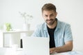 Happy intern or marketing manager using computer looking at came Royalty Free Stock Photo