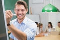 Smiling businessman writing on whiteboard with marker Royalty Free Stock Photo