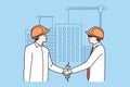 Smiling businessmen handshake at construction site