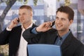 Smiling businessmen making phone call