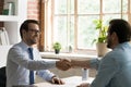 Smiling businessmen handshake closing deal at meeting Royalty Free Stock Photo