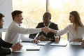 Smiling businesspeople handshake closing successful deal at meeting Royalty Free Stock Photo