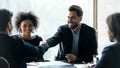 Smiling businesspeople shake hands closing deal at meeting Royalty Free Stock Photo