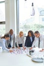 Smiling businesspeople solving a puzzle on an office table Royalty Free Stock Photo