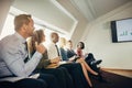 Smiling businesspeople watching a presentation in an office Royalty Free Stock Photo