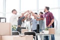 Smiling businessteam clinking glasses , celebrating success in the office