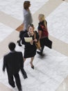 Smiling Businesswoman Amid Blurred Walking People