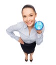 Smiling businesswoman with blue clock Royalty Free Stock Photo