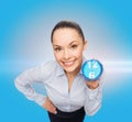 Smiling businesswoman with blue clock Royalty Free Stock Photo