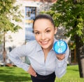 Smiling businesswoman with blue clock Royalty Free Stock Photo