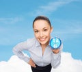 Smiling businesswoman with blue clock Royalty Free Stock Photo