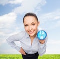 Smiling businesswoman with blue clock Royalty Free Stock Photo