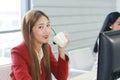 Smiling businesswoman Call Center hand holding a cup of hot coffee. Technical Support staff or receptionist phone operator Royalty Free Stock Photo