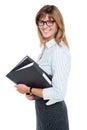 Smiling businesswoman carrying important files Royalty Free Stock Photo