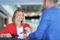 Smiling businesswoman communicates with a man in cafe Royalty Free Stock Photo