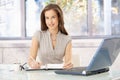 Smiling businesswoman at desk