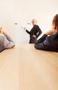 Smiling businesswoman drawing a graph for her colleagues on the whiteboard Royalty Free Stock Photo