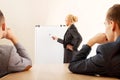 Smiling businesswoman drawing a graph for her colleagues on the whiteboard Royalty Free Stock Photo