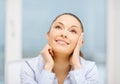 Smiling businesswoman dreaming in office