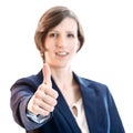 Smiling businesswoman giving a thumbs up