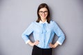 Smiling businesswoman in glasses over gray background Royalty Free Stock Photo