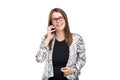 Smiling businesswoman in glasses talking on mobile phone. Beautiful young girl in Blazer on white isolated background Royalty Free Stock Photo