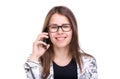 Smiling businesswoman in glasses talking on mobile phone. Beautiful young girl in Blazer on white isolated background Royalty Free Stock Photo