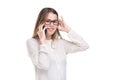 Smiling businesswoman in glasses talking on mobile phone. Beautiful young girl in white shirt on white isolated background talking Royalty Free Stock Photo