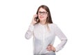 Smiling businesswoman in glasses talking on mobile phone. Beautiful young girl in white shirt on white isolated background talking Royalty Free Stock Photo