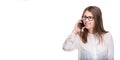 Smiling businesswoman in glasses talking on mobile phone. Beautiful young girl in white shirt on white isolated background talking Royalty Free Stock Photo