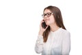 Smiling businesswoman in glasses talking on mobile phone. Beautiful young girl in white shirt on white isolated background talking Royalty Free Stock Photo