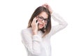 Smiling businesswoman in glasses talking on mobile phone. Beautiful young girl in white shirt on white isolated background talking Royalty Free Stock Photo