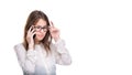 Smiling businesswoman in glasses talking on mobile phone. Beautiful young girl in white shirt on white isolated background talking Royalty Free Stock Photo