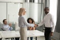 Smiling businesswoman handshake black employee greeting in office Royalty Free Stock Photo