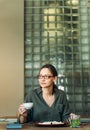 Smiling businesswoman having lunch break at office desk Royalty Free Stock Photo