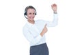 Smiling businesswoman with headset pointing